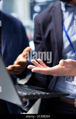 Team of diverse male specialists working together in solar power factory, demonstrating inclusive teamwork and innovation for the production line. Industrial manufacturing process. Close up. Stock Photo