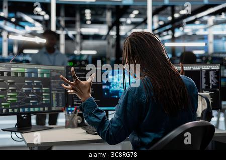 Disgruntled server room worker raging, irked by bugs while using AI tools. Mad programmer fed up with broken data center equipment needed to run artificial intelligence and machine learning Stock Photo