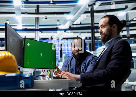Diverse specialists for energy looks at copy space collaborating on solar power, working on photovoltaics design and factory implementation. Corporate oversight with technical expertise. Stock Photo