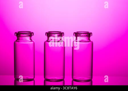 Empty little bottles on nice pink background. Stock Photo