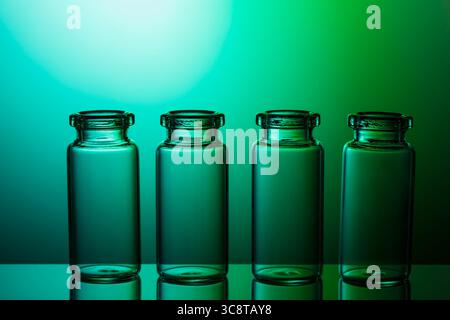 Empty little bottles on nice blue green gradient background. Stock Photo
