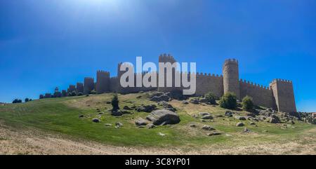 4k panoramic view of the mighty medieval wall and towers surrounding the old town of Avila, Spain Stock Photo