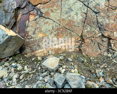 rocks wall in a granite quarry. colorful natural textured background. closeup view. Stock Photo