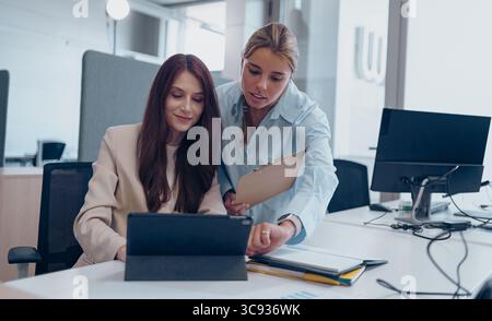 Engaging Collaborative Meeting in a Modern Office Setting with Technology Integration Stock Photo