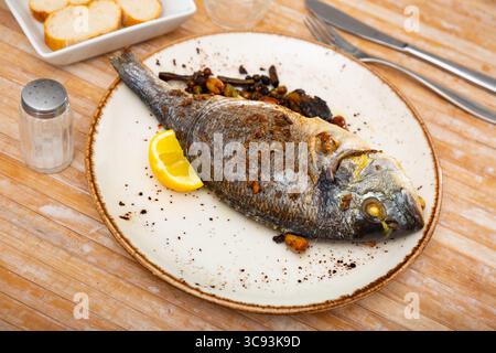 Delicious grilled gilthead bream with lemon Stock Photo