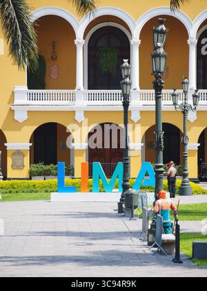 Lima city sign at main square in front of the city hall facade. The ...