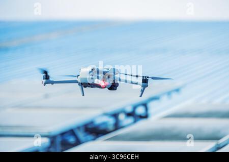 Engineer drone, UAV solar roof inspector, flying drone use to inspect solar panel industry building concept Stock Photo