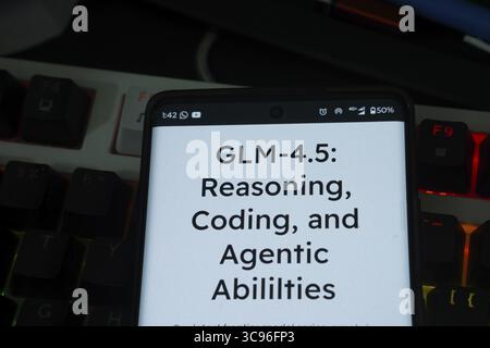 Screen showing GLM-4.5 model's features with a dark, illuminated keyboard Stock Photo