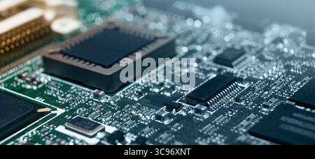 Detailed inspection reveals finely etched circuitry and various electronic components on a modern circuit board. Stock Photo