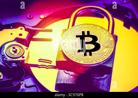 Padlock with cryptocurrency bitcoin on computer hard disk drive HDD. Internet data privacy information security concept. Electronic money cryptocurren Stock Photo