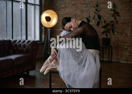 Elegant ballerina in a beautiful tutu practicing her moves in a serene studio setting Stock Photo