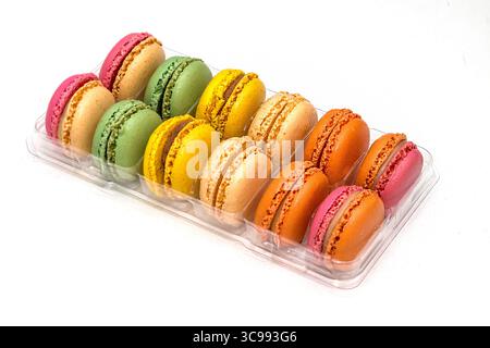 Sweet colorful macarons in plastic box isolated on white Stock Photo