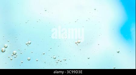 Light aqua background with floating micro bubbles. Minimalist clean blue surface with tiny air bubbles. Perfect for health, water, and beauty themes. Stock Photo