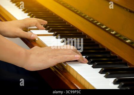 Man hands playing piano, close up. Stock Photo