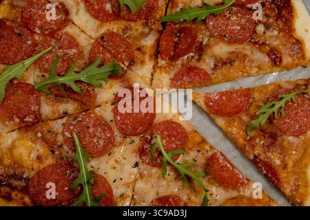Pepperoni Pizza close-up. Mozzarella cheese, salami and rucolla. Italian pizza, top view Stock Photo