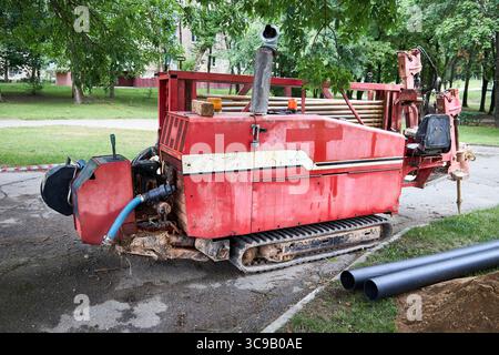 Directional drill machine or Drilling rig stands on paved asphalt. Horizontal directional drilling machine, drill rig. Trenchless method of installing Stock Photo