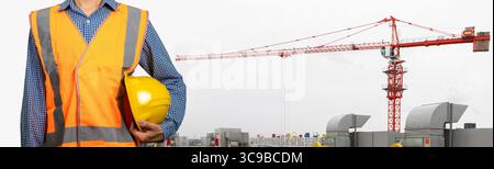 Engineer standing with Industrial construction crane on background. (With Clipping path) Stock Photo