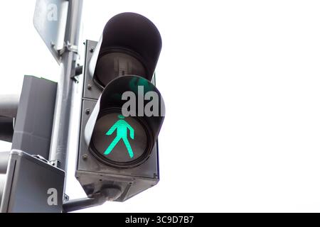 Traffic lights with the green light lit for pedestrians. Isolated on white background. Stock Photo
