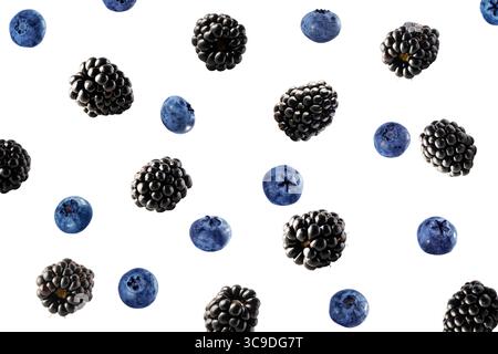 Falling blackberries and blueberries isolated on white. Background of blackberries and blueberries. Sweet berries isolated on white background cutout. Stock Photo