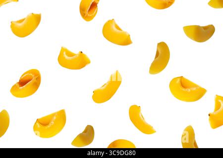 Falling apricot slices isolated on white. Background of apricots. Sweet fruit isolated on white background cutout. With clipping path. Stock Photo