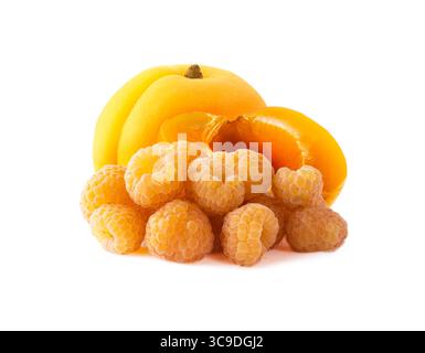 Raspberries and apricot. Yellow raspberries and apricot pieces isolated on white background. Juicy and delicious raspberries in close-up. Stock Photo