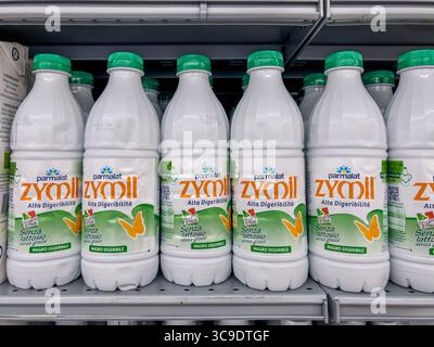Italy - August 5, 2025: Parmalat Zymil highly digestible lactose-free milk in plastic bottles displayed on shelves for sale in an Italian supermarket. Stock Photo