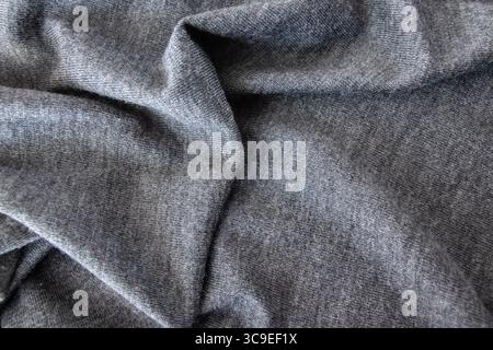 Texture wool or cashmere fabric. Textile gray knitted cloth background. Jacket or coat for winter weather. Stock Photo
