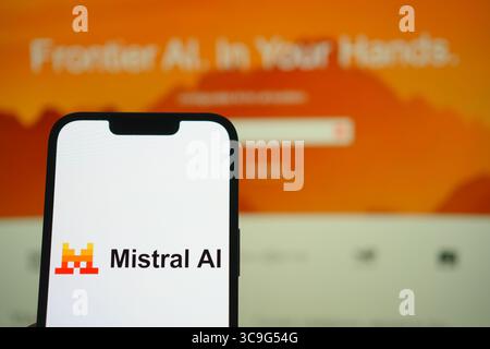 Roosendaal, The Netherlands - August 05, 2025: A mobile phone displaying the company logo of Mistral Ai, with the company website in the background. Stock Photo