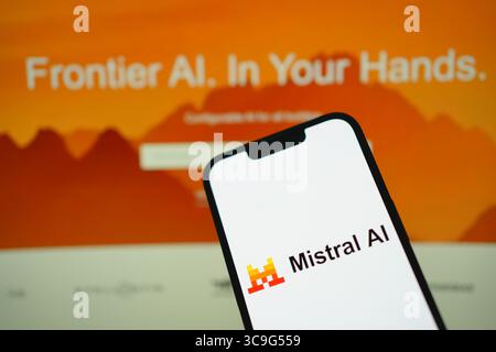 Roosendaal, The Netherlands - August 05, 2025: A mobile phone displaying the company logo of Mistral Ai, with the company website in the background. Stock Photo