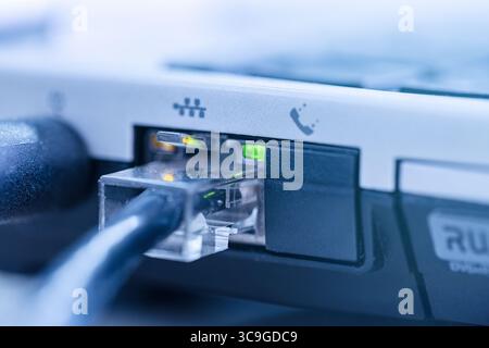 LAN network cable connected to RJ-45 port notebook close up. Stock Photo