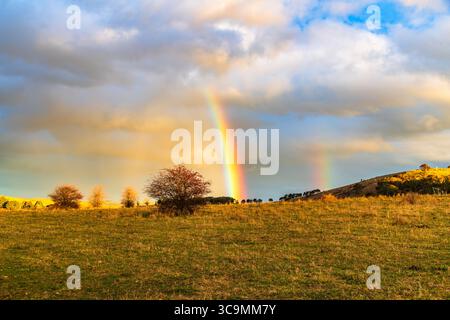 Rainbow over the countryside at Blayney in the Central West of NSW, Australia. Stock Photo