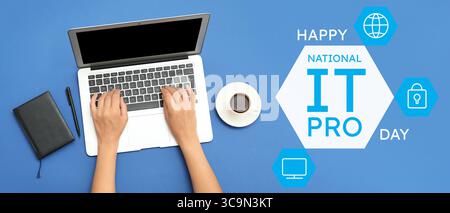 Programmer working with modern laptop on blue background. National IT Professionals Day Stock Photo