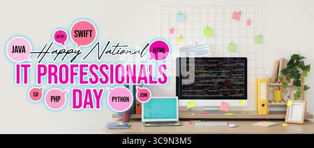 Computer monitor and laptop with codes on programmer's desk in light office. National IT Professionals Day Stock Photo