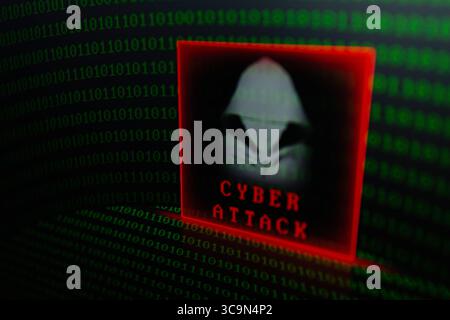 February 27, 2023, Asuncion, Paraguay: Visual representation of hacker and the words ''cyber attack'' backdropped by binary code digits displayed on a screen. (Credit Image: © Andre M. Chang/ZUMA Press Wire) Stock Photo