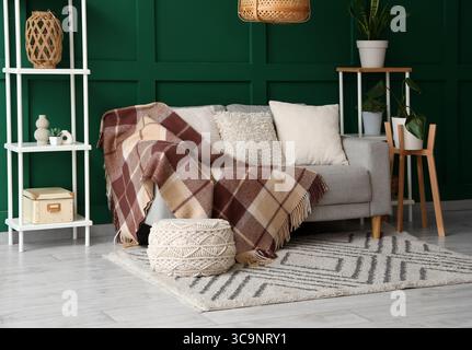 Interior of living room with sofa and knitted blanket Stock Photo