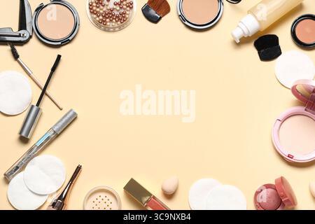 Frame made of cotton pads and different cosmetic products on beige background, closeup Stock Photo