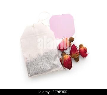 Composition with dry tea roses and tea bag isolated on white background, closeup Stock Photo