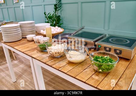 A Brightly Lit Kitchen Counter Displaying Ingredients and Cooking Equipment for Meal Preparation in a Cozy Culinary Environment Stock Photo