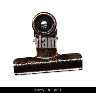 Closeup of an old rusty metal binder clip with a circular hole, isolated on white background. Vintage office supply object Stock Photo