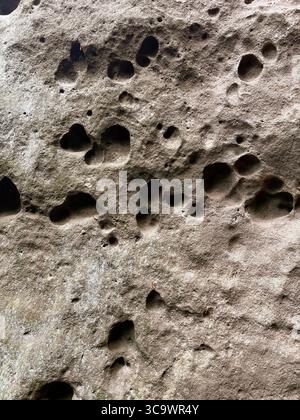 Texture and background of stones. Texture of rock. Natural dents in stones. Old stone wall. Stock Photo