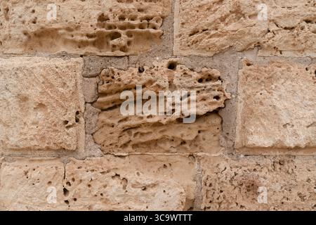Close-up of weathered limestone wall with natural texture and historic character,  North Cyprus Stock Photo