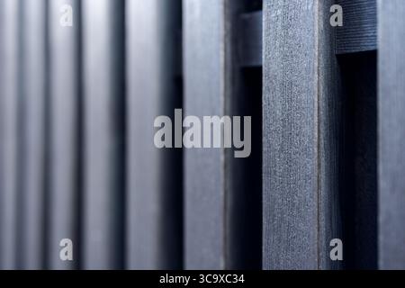 Detailed texture of aligned wooden boards in dark tones captured with shallow depth of field ideal for background use or graphic composition Stock Photo