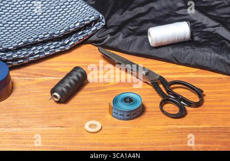 Sewing stuff - thimble, thread, scissors, needle, button, meter, on a wooden table Stock Photo