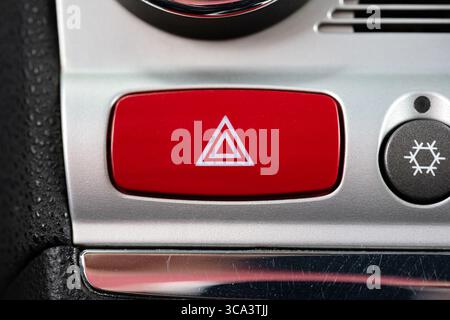 Car emergency stop or hazard lights button on dashboard. Close up shot, no people Stock Photo