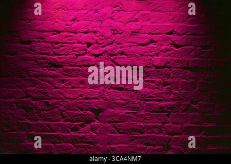 Grunge neon pink brick wall texture background. Magenta colored brick wall texture architecture pattern Stock Photo