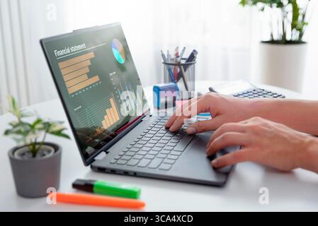Man using 2 in 1 laptop to financial data analysis. Analyst at work. Stock Photo