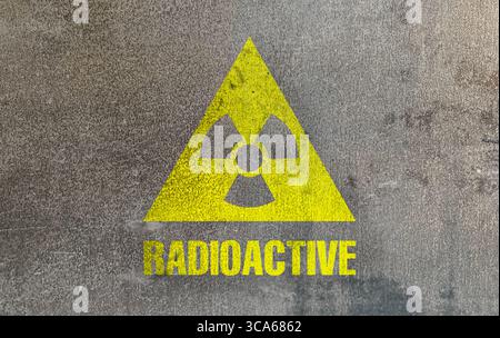 Radioactive sign on grey textured surface. Radiological pollution Stock Photo