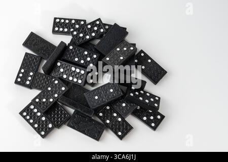 wooden tiles used in a game of dominoes randomly laid out Stock Photo