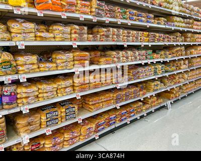 Variety of bread loaves on the shelves for sale in a supermarket. Utah, USA. Stock Photo