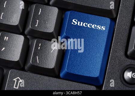 Computer keyboard blue key with Success label inscription. Business concept. Close up image. Stock Photo